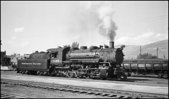 NP 1185, Class G-2 at Missoula with engineer in locomotive cab.