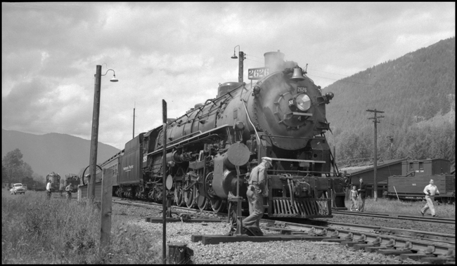 NP 2626, Class A-1, stops at Lester, WA on her last trip under steam.  Rail fans scampering for photographs.