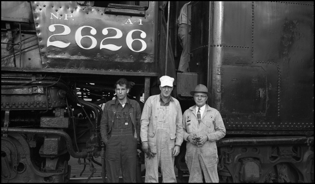 Fireman Lawrence Wheir, Engr Vernon Pringle, and Road Foreman Pat Smith in front of NP 2626, Class A-1 at Auburn, WA.and fireman Lawrence Wheir on NP 2626, Class A-1 at Auburn.