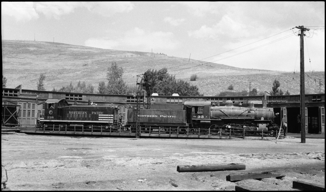 NP Diesel switcher 138 moving NP 33, Class Y locomotive on turntable at Missoula. 