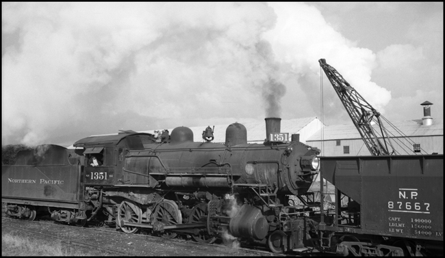 NP 1351, Class S-4 under steam and connected to an open top hopper in Missoula