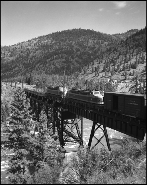 MILW electric locomotives lead an extra west bound freight train near Cyr, MT.