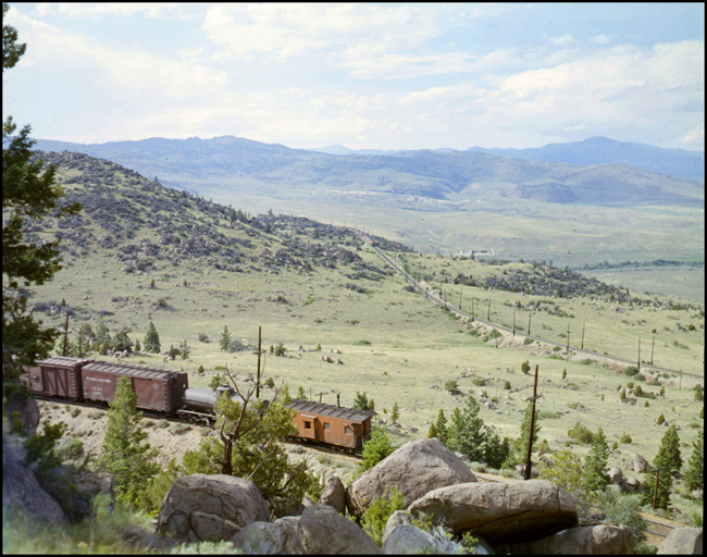 The tail-end of an extra MILW freight train heading west near Cedric, MT.