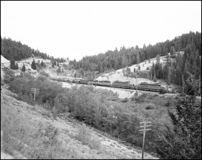 MILW hotshot freight 263 near Donald, MT, with 2 Little Joes and 2 GP-9s, auto carriers on flat cars.