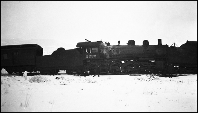 Head-on collision between NP NCL and local passenger  train near Welch, MT, showing wrecked NCL road engine no. 2225 and RPO lifted off track.