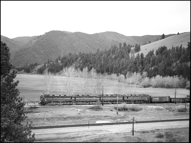 The NP tracks in the foreground are quiet, and the action is on the more lightly used Milwaukee main today as an extra passes behind a four-unit boxcab electric