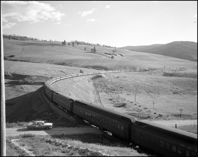 Heavyweight sleepers trail the westbound Mainstreeter.  It could be a troop movement or a new summer staff for the Yellowstone Park concessions or any of a variety of groups, riding the sleepers west