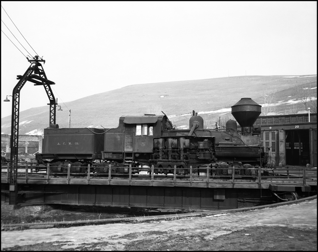 A Shay, weathered from years in the woods, poses on a turntable, a luxury it probably seldom used during its career on private industrial railroads.  Not impressive by the standards of the power that used to call this roundhouse home, but it still is a steam engine.