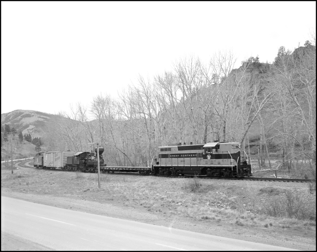 The diesel, a 1500 hp dual purpose machine built in 1951 usually hauls secondary passenger trains.  The steam engine spent its working life hauling logs for the Anaconda Mining outfit.  They share a stretch of track on a Great Northern secondary line in Montana