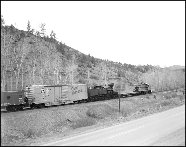 The diesel, a 1500 hp dual purpose machine built in 1951 usually hauls secondary passenger trains.  The steam engine spent its working life hauling logs for the Anaconda Mining outfit.  They share a stretch of track on a Great Northern secondary line in Montana
