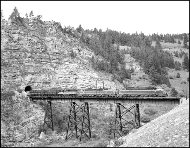 MILW E21, leads an east bound extra across the trestle near Eagle Nest, MT