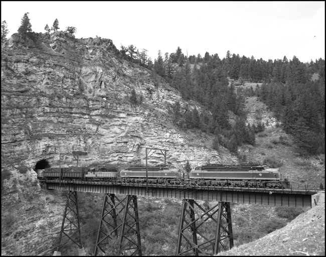MILW E21, leads an east bound extra across the trestle near Eagle Nest, MT