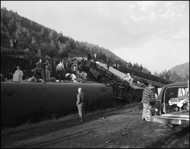 Wreckage of NP coach 353 and others.  Train No. 26, the North Coast Limited, derailed 1 mile west of Evaro, MT taking one life.