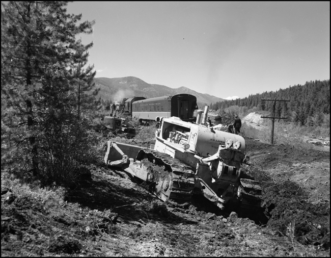 Wreckage of NP train No. 26 clean up. The North Coast Limited, derailed June 10, 1962 1 mile west of Evaro, MT taking one life.