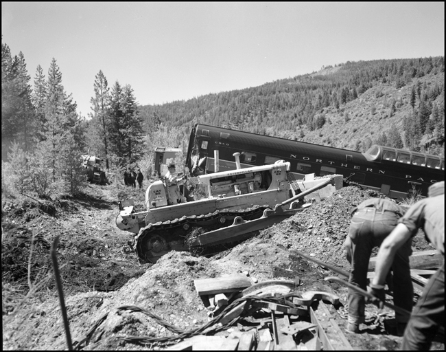 Wreckage of NP train No. 26 clean up. The North Coast Limited, derailed June 10, 1962 1 mile west of Evaro, MT taking one life.
