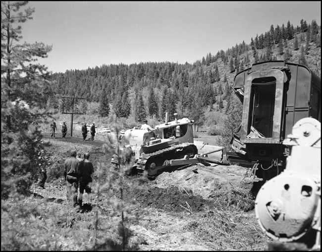 Wreckage of NP train No. 26 clean up. The North Coast Limited, derailed June 10, 1962 1 mile west of Evaro, MT taking one life.
