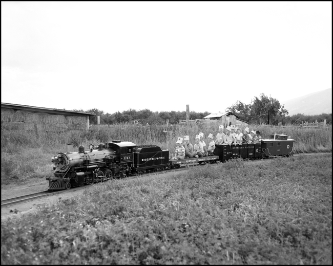 Children riding scale train pulled by replica of steam NP 2223 at Hamilton, MT.