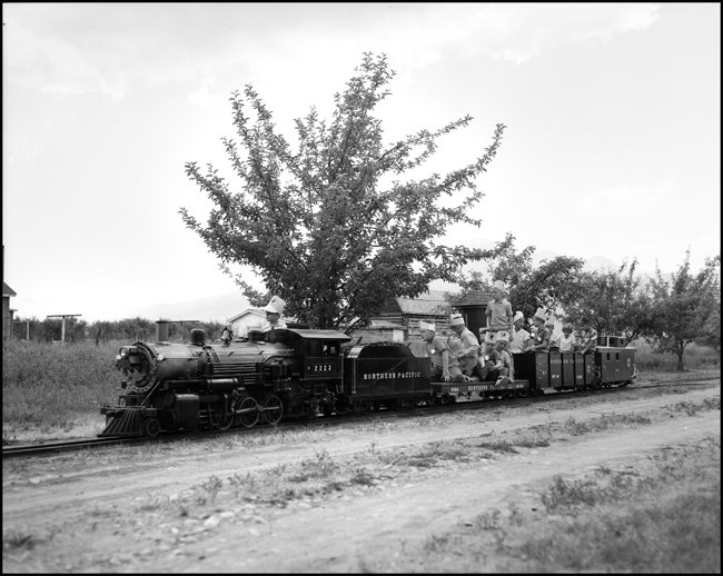 Children riding scale train pulled by replica of steam NP 2223 at Hamilton, MT.