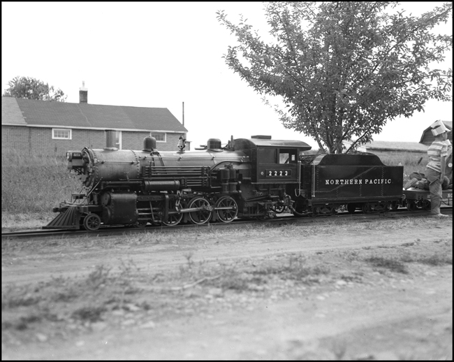 Children riding scale train pulled by replica of steam NP 2223 at Hamilton, MT.