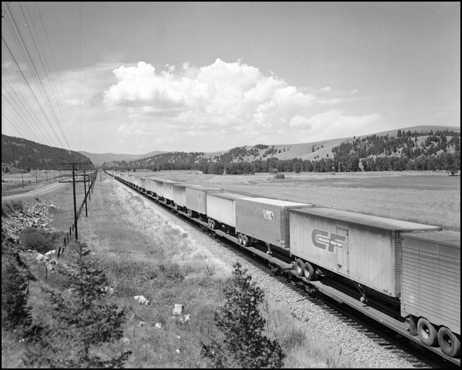 NP train No. 600 with Consolidated Freightways trailers near Elliston, MT.