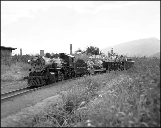 Children riding scale train pulled by replica of steam NP 2223 at Milltown, MT.