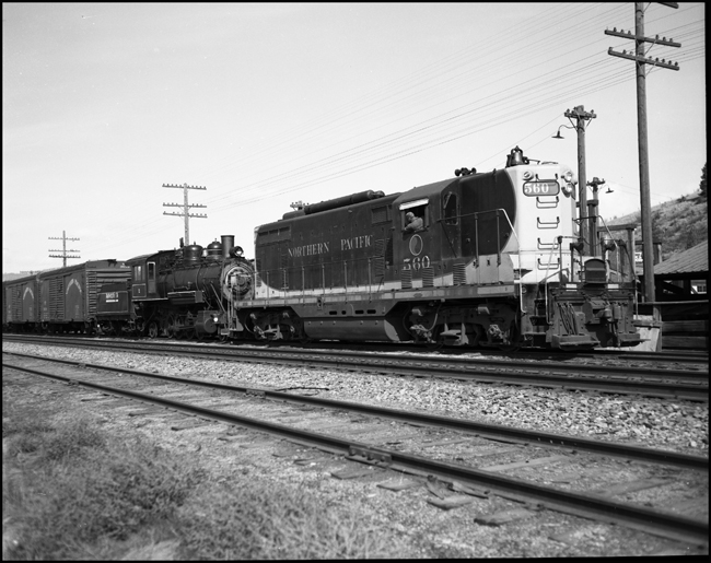 Rayonier Logging Company #2, a 2-8-2, Baldwin coupled to NP 560 an EMD GP-7 at Plains, MT.