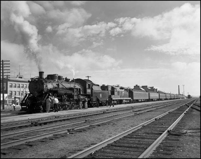 CBQ 4960, a 2-8-2 steam locomotive and a diesel helper with passenger cars at Billings, Montana.