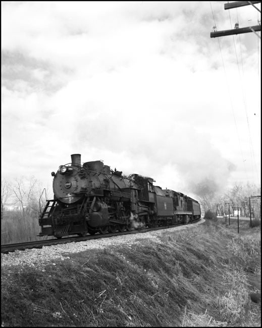 CBQ 4960, a 2-8-2 steam locomotive and a diesel helper with passenger cars south of Laurel, MT.