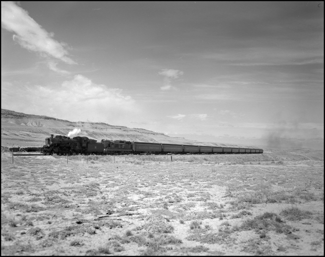 CBQ 4960, a 2-8-2 steam locomotive and a diesel helper with passenger cars south of Bridger, MT.