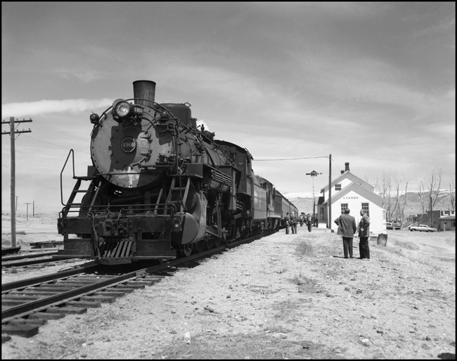 CBQ 4960, a 2-8-2 steam locomotive and a diesel helper with passenger cars stopped at Frannie, Wyoming.