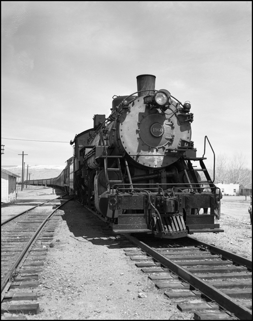 CBQ 4960, a 2-8-2 steam locomotive and a diesel helper with passenger cars stopped at Frannie, Wyoming.