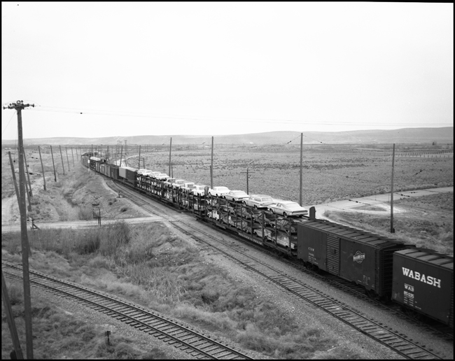 MILW Train No. 261 with 5 diesel electric locomotives on freight drag leaving Othello, WA