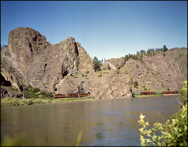 GN XW passes through rock tunnel near Craig, powered by 4 EMD GP locomotives and on GE U boat.