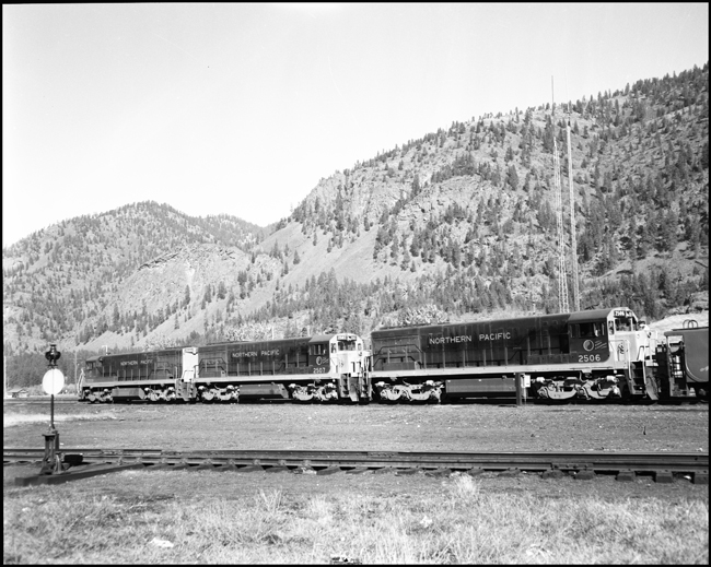NP U-25C locomotives at Paradise, coupled onto a caboose.