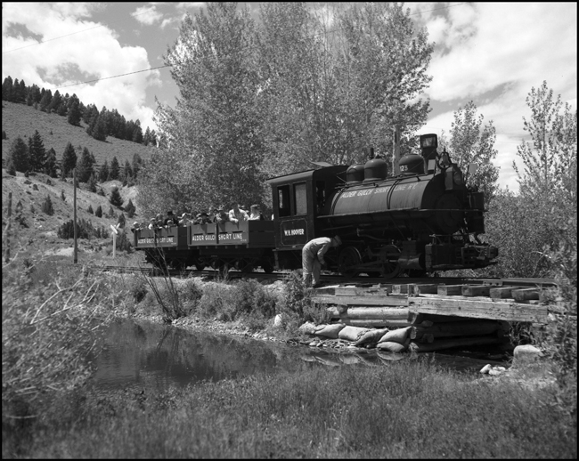 Alder Gulch Short Line (AGSL)  123 and loaded flat cars with Engineer checked motive power prior to crossing bridge before arriving Virginia City, MT.  