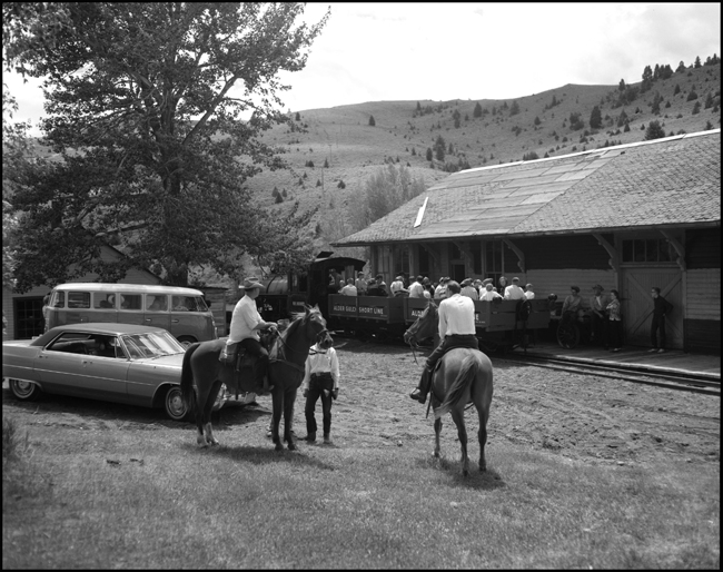 Alder Gulch Short Line (AGSL)  123 and loaded flat cars arrive at Virginia City, MT and train is meet by cowboys.  