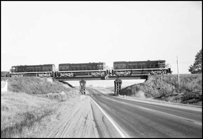 NP X2506W passing over bridge near DeSmet, MT.  NP Monad identifies bridge as Northern Pacific.