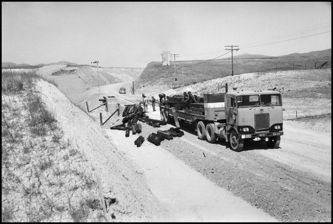 Grade construction near Grass Valley, MT. NPT truck delivers ties.