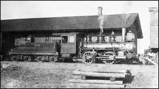 NP 0-6-0 no. 1056 and crew take a break at the Moorhead, MN, depot.