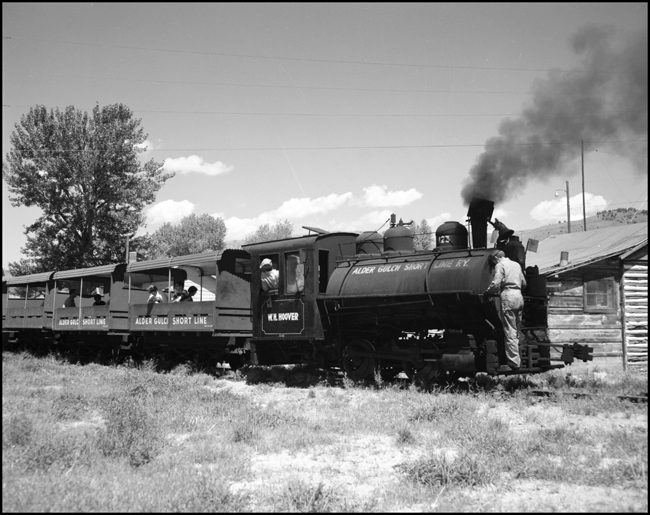 Engine crewmen ride cab and pilot beam of little 0-4-0 no. 123 on Alder Gulch Short Line excursion train at Virginia City, MT.
