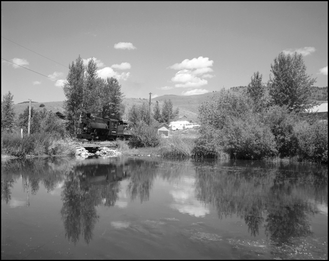 Little 0-4-0 no. 123 leads Alder Gulch Short Line excursion train past the lake at Virginia City, MT.