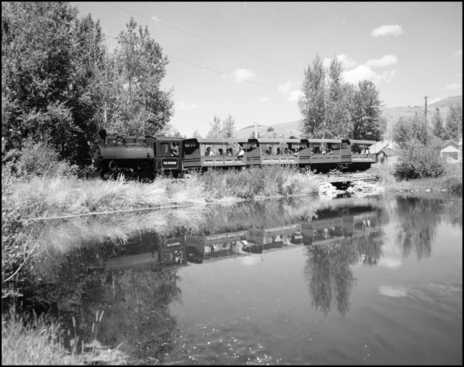 Little 0-4-0 no. 123 leads Alder Gulch Short Line excursion train past the lake at Virginia City, MT.