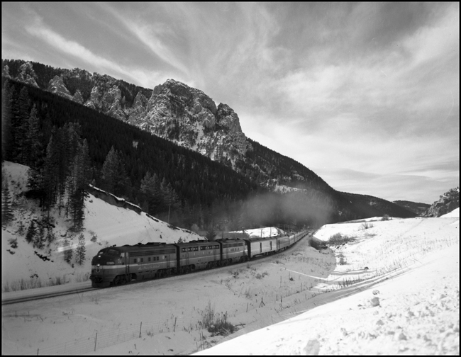 Three-unit Fs lead train 26, eastbound NCL, upgrade on a snowy but sunny morning at West End, MT.