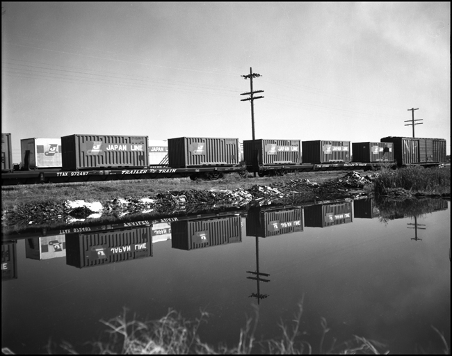 Two flat cars with short containers sit at the Sierra Talc plant at Three Forks, MT.