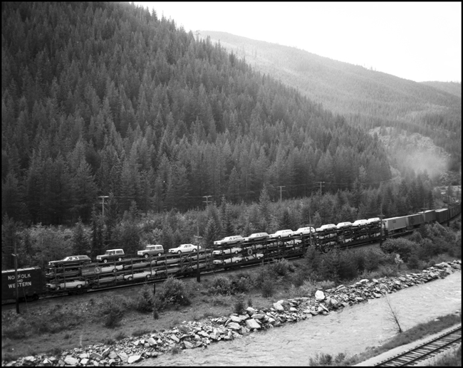 Three tri-level auto carriers in westbound MILW freight no. 261 near Saltese, MT.