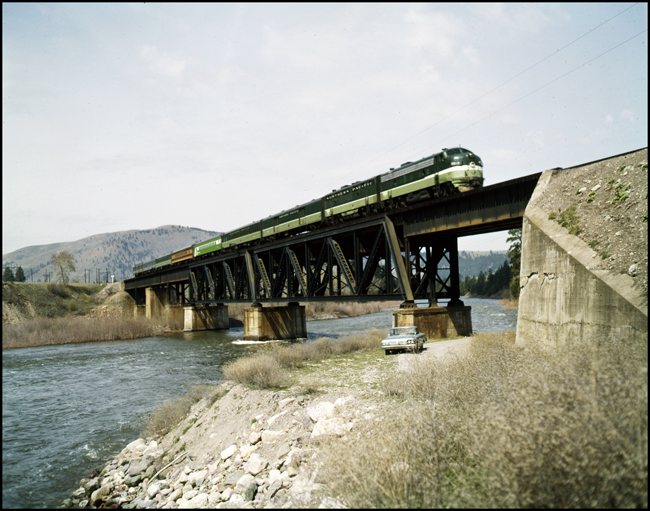 Color photograph of BN passenger train #30, BN 9802, on bridge near Bonner, MT.  This is the last acheduled run of this train.  There are seven cars in train.  Bn crew is Bailey and Dunstan.