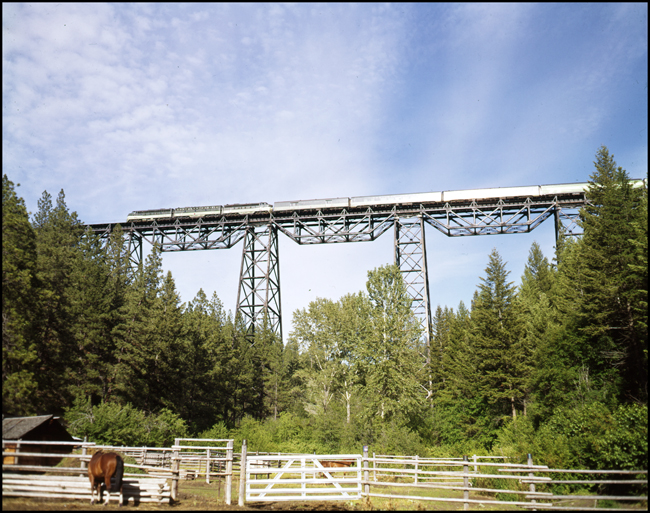 Color picture of Amtrak passenger train west bound with a set of BN F units A-B-A in NP paint crossing Marent Trestle, MT.