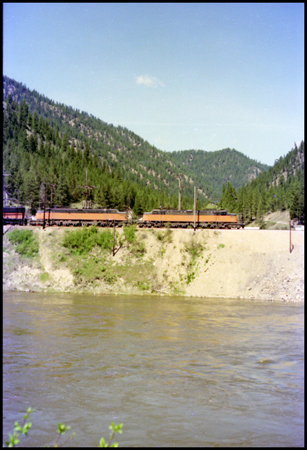Two MILW electrics E-78 and E-72 in view, followed by a MILW Diesel road units 4008 and 10 moving XE near Superior, MT. 
