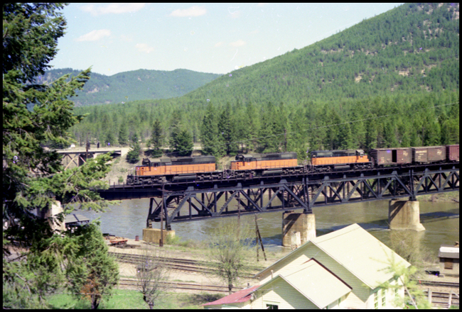 MILW XW 3037, 3000 and 3019 road units pulling freight on bridge near St Regis