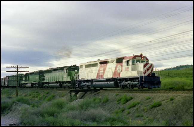 BN XW with lead locomotive BN 1976, painted in Freedom locomotive color scheme west of Missoula.